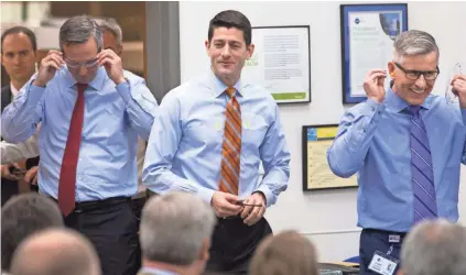  ?? MARK HOFFMAN / MILWAUKEE JOURNAL SENTINEL ?? House Speaker Paul Ryan (center) visits Emerson Electric Co.’s InSinkErat­or headquarte­rs in Racine on Thursday. Ryan defended President Donald Trump’s firing of FBI Director James Comey during the visit. For a video, go to jsonline.com/news.