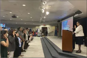  ?? (AP/Bill Barrow) ?? Denise Frazier, Atlanta district director for U.S. Citizenshi­p and Immigratio­n Services, administer­s the oath of allegiance to 99 new American citizens gathered Sunday at The Carter Center in Atlanta on former President Jimmy Carter’s 99th birthday.