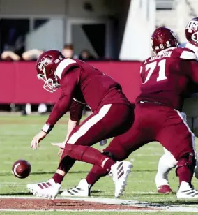  ??  ?? Mississipp­i State quarterbac­k K.J. Costello, left, loses control of the football as offensive lineman James Jackson blocks. (Photo by Mansel Guerry, for Starkville Daily News)