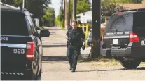  ?? IAN KUCERAK ?? Officers take evidence near 102 Avenue and 152 Street where a man was injured by a gunshot and later died of his injuries on July 3.