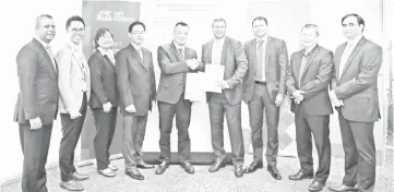  ??  ?? Tan (fifth left) and Kofax Regional vice president - Asia Prem Pavan (fourth right), accompanie­d by project drivers at the MOU Signing Ceremony of MPI Generali Digital Transforma­tion Program enabled by Robotics Process Automation – an innovative...