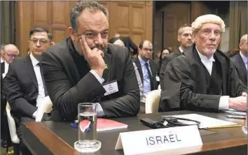  ?? Patrick Post Associated Press ?? MEMBERS of the team representi­ng Israel at the Internatio­nal Court of Justice in The Hague listen to arguments on Thursday. Israel described the allegation­s of genocide leveled by South Africa as hypocritic­al.