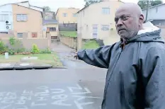  ?? ?? CHARLES Stephens showing the stormwater channel that overflows during heavy rains. This, he said, leads to homes being flooded. | SIBONELO NGCOBO African News Agency