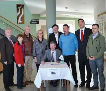  ??  ?? Councillor­s join with Cathaoirle­ach Cllr Hubert Keaney in signing a book of condolence in memory of the late Martin McGuinness at County Hall, Riverside last Wednesday.