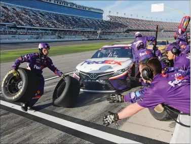  ?? AP Photo/Terry Renna ?? Daytona winner: Denny Hamlin's crew changes tires and refuels during a pit stop during the NASCAR Daytona 500 auto race at Daytona Internatio­nal Speedway, Monday, Feb. 17, 2020, in Daytona Beach, Fla. Sunday's race was postponed sue to rain.