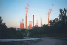  ?? Sharrett, Bloomberg file Luke ?? Emissions rise from the American Electric Power Co.’s coal-fired John E. Amos Power Plant in Winfield, W.VA., on July 18.