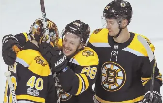  ?? STAFF PHOTO BY MATT STONE ?? HAPPY ENDING: Tuukka Rask gets a big hug from David Pastrnak after the Bruins’ win over the Lightning last night.