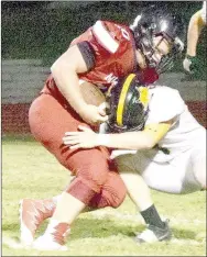  ?? PHOTO BY RICK PECK ?? McDonald County running back Jake Will gets tackled just short of the goal line by Cassville’s Troy Rose during the Wildcats 33-22 win Friday night at MCHS.