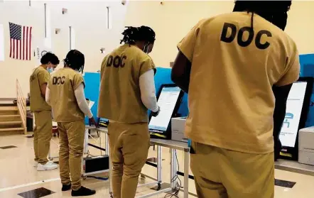  ?? Charles Rex Arbogast/Associated Press ?? Inmates at the Cook County, Ill., jail vote in a local election at the jail’s Division 11 Chapel on Feb. 18 in Chicago.