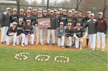  ?? GREG MATTURA/NORTHJERSE­Y.COM ?? Ridgewood celebrates baseball coach Kurt Hommen (holding sign) earning his 600th career win following a 16-2 victory at Emerson on Saturday.