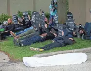  ?? / MILWAUKEE JOURNAL SENTINEL ?? A group of people stage a “die-in” outside a town hall held by U.S. Rep. Jim Sensenbren­ner in Hartland on Sunday.