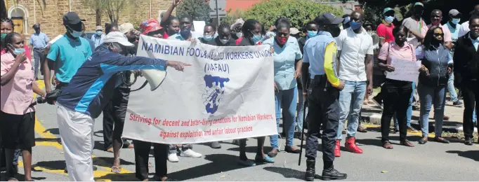  ?? Photo: Maria Amakali ?? The fight continues… Shoprite Namibia workers marched in Windhoek yesterday.