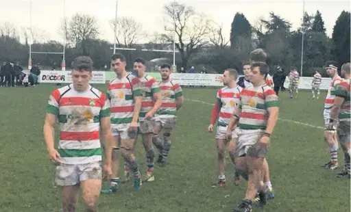  ??  ?? ●●Stockport players leave the field following their victory against Firwood Waterloo