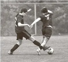  ?? Julian Gavaghan ?? Petro Kaskampas of EDSS dribbles past his opponent while teammate Devin Hamelin puts in a fine tackle (bottom) in senior boys’ soccer on Tuesday at RIM Park. But Elmira battled in vain against a very skilled side from Forest Heights Collegiate and lost 8‡0.