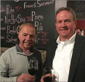  ?? JANET PODOLAK FOR THE NEWS-HERALD ?? Landlord Art Iacofano, left, and Dan Campbell, Austin’s Grill owner, prepare to toast the long-awaited opening of the new Mentor steakhouse.