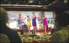  ?? AP PHOTO ?? North Korean performers entertain customers at the Okryugwan restaurant in Beijing. Chinese news reports say the government has ordered most North Korean-owned businesses and ventures with Chinese partners to close under UN sanctions imposed over the...