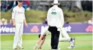  ??  ?? Worry: James Anderson tries to shake off ‘tightness’ in his calf before giving up