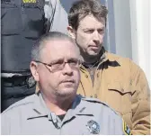  ??  ?? John Mark Tillmann, right, is escorted by sheriffs from provincial court in Dartmouth on Feb. 27, 2013. Tillmann died on Dec. 23, 2018, at the age of 57.