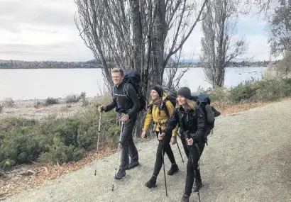  ?? PHOTO: KERRIE WATERWORTH ?? Stride time . . . Te Araroa Trail trampers Lukas Waser (21), of Switzerlan­d, and Alexandra Hog (28, centre) and Katrina Steiert (28), both of Germany, on their first day back on the trail after spending the Covid19 lockdown in Wanaka.