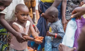  ?? (Reuters) ?? A REFUGEE BOY from Burundi who fled the ongoing violence and political tension washes his hands at the Nyarugusu refugee camp in western Tanzania in 2015.