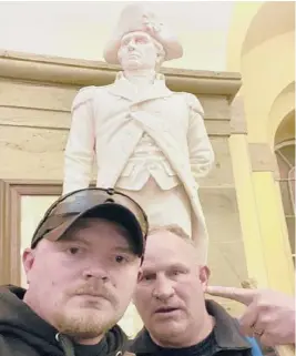  ?? U.S. CAPITOL POLICE ?? Police Officers Jacob Fracker, 29, left, and Sgt. Thomas Robertson, 48, pose inside the U.S. Capitol after supporters of Donald Trump stormed the building Jan. 6 in Washington. The pair are officers of the Rocky Mount Police Department in Virginia.