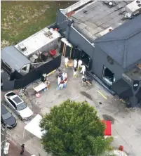  ?? (Carlo Allegri/Reuters) ?? FORENSICS INVESTIGAT­ORS work at the scene of a mass shooting at the Pulse gay night club in Orlando, Florida, on June 12, 2016. Omar Mateen, a New York-born security guard, killed 49 people and wounded 58 others in an Islamist terrorist attack.