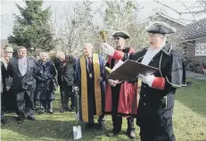  ??  ?? Town crier Richard Plowman makes a proclamati­on at the ceremony