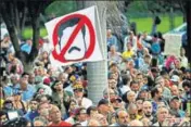  ??  ?? An antigovern­ment demonstrat­or waves a flag against Venezuela's President Nicolas Maduro in Caracas on Monday. AP