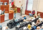  ?? STAFF PHOTO BY TIM OMARZU ?? Savannah Hills Drive resident Chuck Underwood (standing at podium) warns the Chattanoog­a-Hamilton County Regional Planning Commission Monday about sinkholes he said could result if developer Frank Goodwin blasts through bedrock to build a new, 48-lot...
