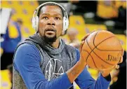  ?? [AP PHOTO] ?? Kevin Durant, drowning out the noise, warms up before an NBA playoff game.