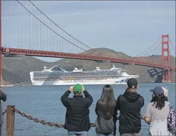  ?? Peter DaSilva For The Times ?? THE GRAND PRINCESS sails under the Golden Gate Bridge in San Francisco on its journey on Monday to the Port of Oakland, where the cruise ship’s passengers would face additional screenings for the coronaviru­s.