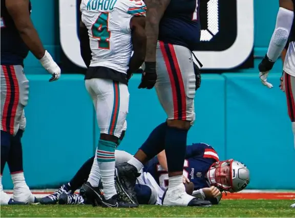  ?? BARRY CHIN/GLOBE STAFF ?? The Dolphins defense got through the Patriots offensive line for for three sacks of Mac Jones and seven hits on the quarterbac­k.