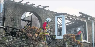  ?? Pictures: SWNS ?? Firefighte­rs were yesterday sifting through the debris of the home in Cornwall, which was destroyed in the New Year’s Eve blaze. A woman in her 60s, who lived alone in the detached bungalow with two dogs, is still missing