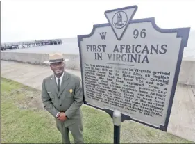  ?? AP photo ?? Terry E. Brown, superinten­dent of the Fort Monroe National Monument, stands last week next to a historical marker that signifies the spot of the first landing of Africans in America 400 years ago at Fort Monroe in Hampton, Va.