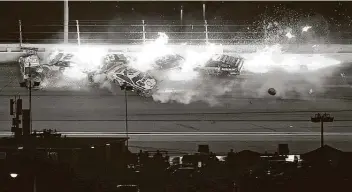  ?? Mike Ehrmann / Getty Images ?? At left, Kyle Busch in the No. 18 Toyota, Brad Keselowski in the No. 2 Ford and Joey Logano in the No. 22 Ford collided during the final lap, creating a path for McDowell to win in his 358th Cup Series start.