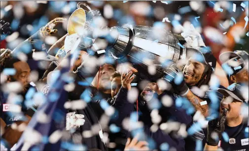  ?? CP PHOTO / SEAN KILPATRICK ?? The Toronto Argonauts celebrate as they hoist the Grey Cup after defeating the Calgary Stampeders in the 105th Grey Cup Sunday in Ottawa.