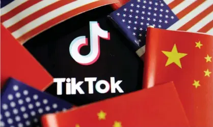  ?? Photograph: Florence Lo/Reuters ?? China and US flags are seen near a TikTok logo.