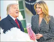  ??  ?? US President Donald Trump pardons Thanksgivi­ng turkey ‘Corn’ as first lady Melania Trump watches.