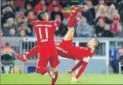  ?? REUTERS ?? Robert Lewandowsk­i (right) displayed his acrobatic skills to net home Bayern Munich’s second goal against Schalke.