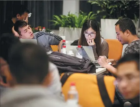  ?? NIU JING / FOR CHINA DAILY ?? A female programmer takes part in a computer system test that involved more than 200 software engineers in Hangzhou, capital of Zhejiang province, in 2017. Fewer than 10 women participat­ed in the event.