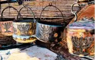  ?? LEANNE ITALIE/AP ?? Cooking pots adorned with menorahs in an outdoor stall near Ksar of Ait-Ben-Haddou in southern Morocco.