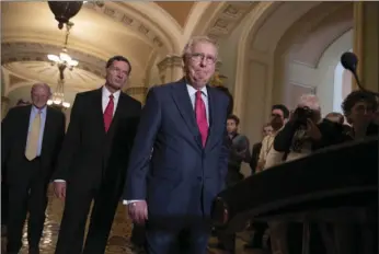  ??  ?? Senate Majority Leader Mitch McConnell, R-Ky., joined by Sen. James Inhofe, R-Okla., a member of the Senate Armed Services Committee (far left) and Sen. John Barrasso, R-Wyo., (second from left) arrives for a news conference on Capitol Hill in...
