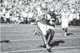  ?? BYRON HETZLER/USA TODAY SPORTS ?? UCLA quarterbac­k Brett Hundley crosses into the end zone to score the winning touchdown in the second overtime against Colorado in Boulder, Colo., on Saturday afternoon.