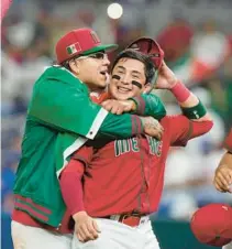  ?? MARTA LAVANDIER/AP ?? Mexico players celebrate after defeating Puerto Rico 5-4 in a World Baseball Classic quarterfin­al Friday in Miami.