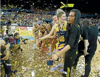  ?? GETTY IMAGES ?? Sunshine Coast Lightning coach Noeline Taurua is covered in confetti after her team’s Super Netball title win in Australia last year.