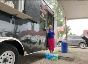  ?? Mead Gruver/ AP ?? Nena Hermosillo stands outside her taco truck in Cheyenne, Wyo., Aug. 1. Cheyenne- based Taco John’s recently sent Freedom’s Edge Brewing Co. in Cheyenne a cease- and- desist letter for using “Taco Tuesday” to advertise the taco truck parked outside on Tuesdays.