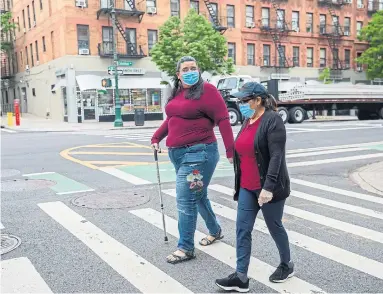  ?? CALLA KESSLER THE NEW YORK TIMES ?? Janet Mendez, left, who spent almost three weeks in Mount Sinai Morningsid­e hospital while being treated for COVID-19, walks with her mother, Maria, in New York City. Janet received an invoice for $401,885.57 (U.S.) for the treatment.