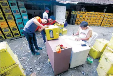  ??  ?? GETTING READY – Employees of the Davao City government prepare the ballot boxes that will be used for the Barangay and Sanggunian­g Kabataan elections on Monday, May 14. (Keith Bacongco)