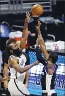  ?? AP photo ?? James Harden of the Nets shoots as the Clippers’ Paul George defends during the first half Sunday.