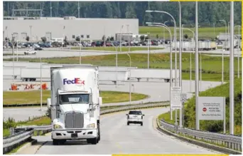  ?? STAFF FILE PHOTO ?? Motorists travel the private Ferdinand Piech Way that leads to Volkswagen’s supplier park. State road builders are working on the last section of a public highway that will directly connect I-75 with Highway 58 through the VW plant site.